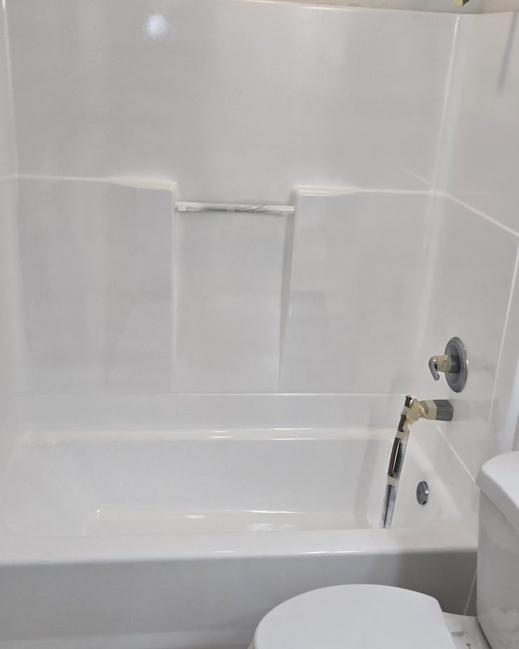 Real bathroom resurfaced by Resurface Oregon — glossy white bathtub ready to use
