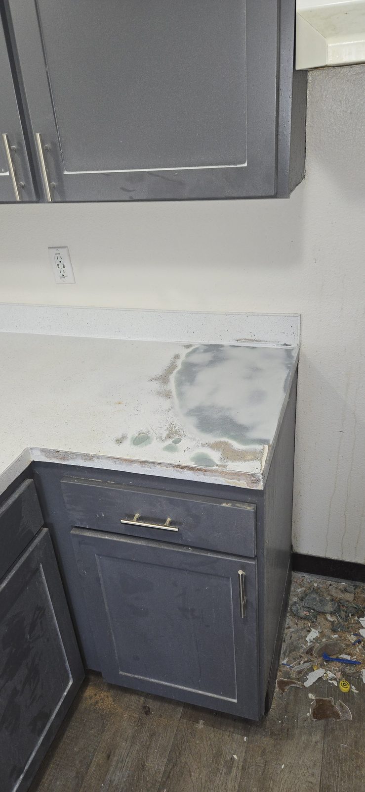 The same kitchen countertop with the first repairs underway, resurfacing in progress