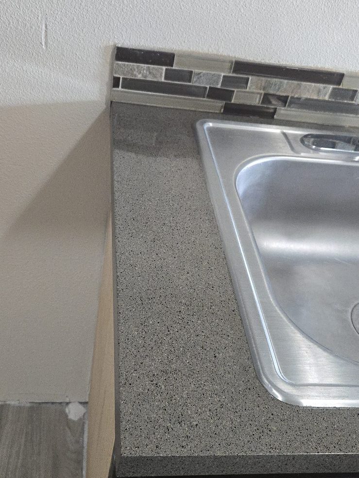 Kitchen countertop and sink resurfaced with a durable granite-look finish by Resurface Oregon