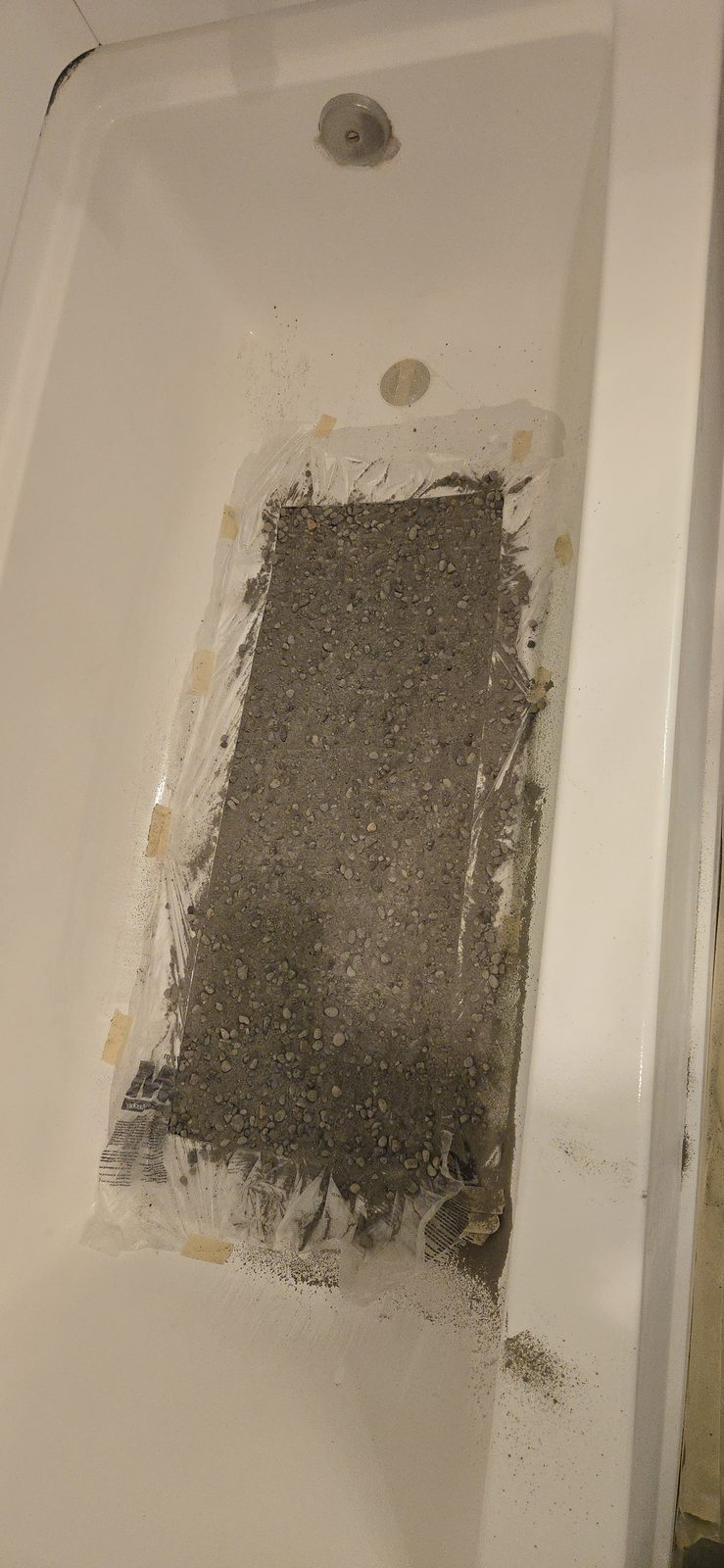 Bathtub interior before resurfacing, covered in heavy brown staining and surface damage